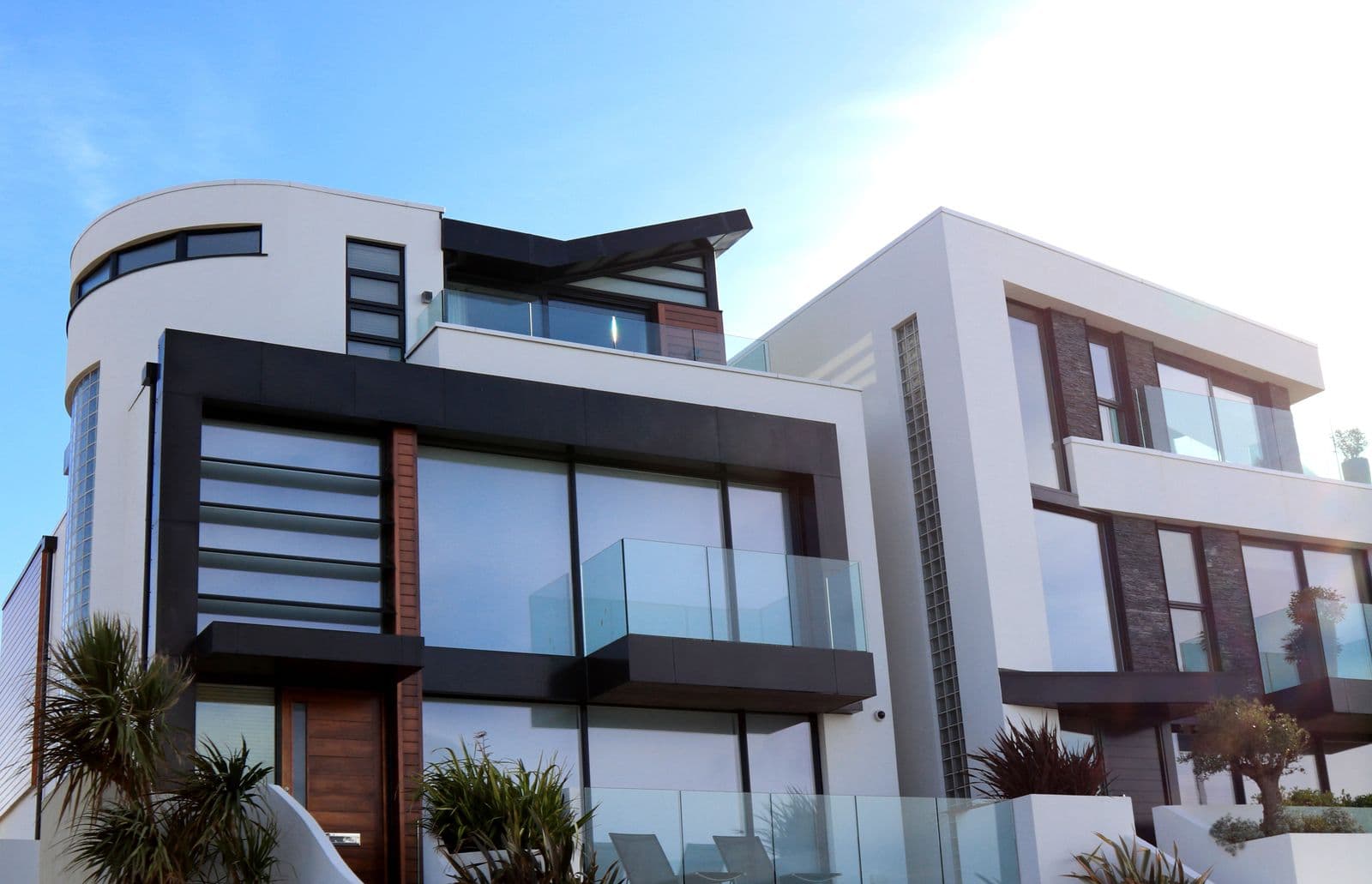 Modern white residential architecture against a clear sky