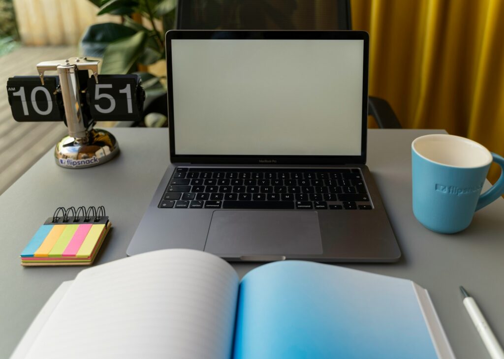 a laptop and a mug on a table